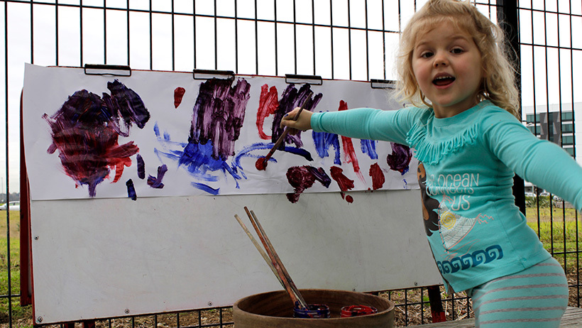 girl painting at daycare