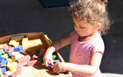 girl playing with blocks at daycare