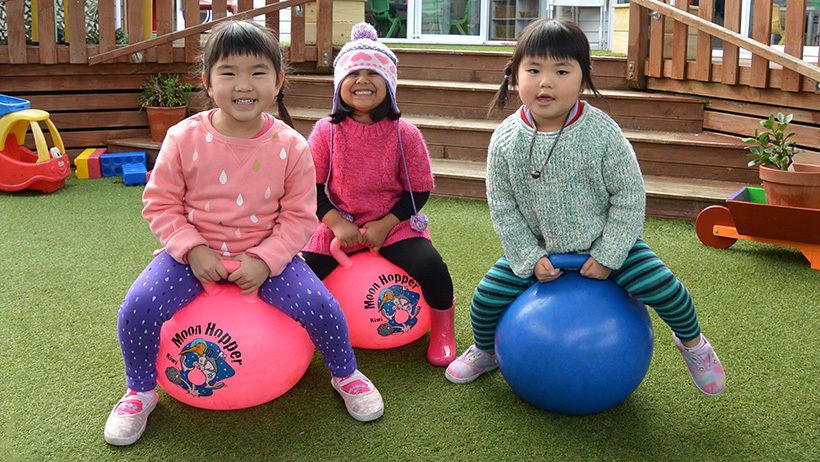 three girls on hoppers at daycare