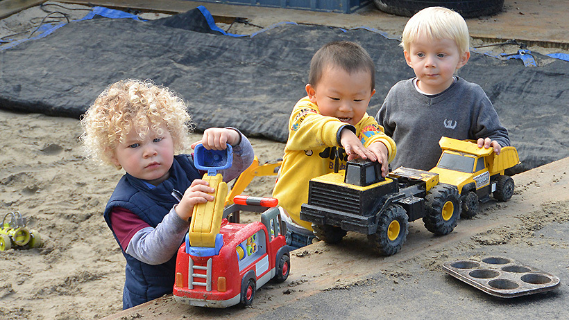 children at daycare playing in sandpit
