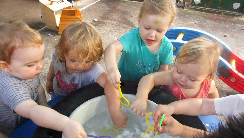 children playing with bubbles at daycare